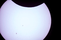 Sunspots and start of eclipse through telescope