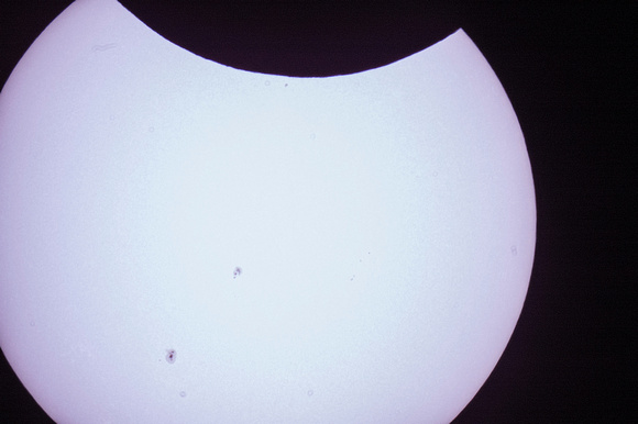 Sunspots and start of eclipse through telescope